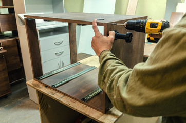 Assembly of hard furniture, close-up drawers for drawers