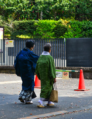 Old women in kimono dress walking on street