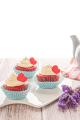 Red velvet heart cupcake with cream cheese frosting and a red heart for Valentine's Day