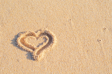 Heart made of shells on the sand at the beach. Valentine's Day. Background. Close up.