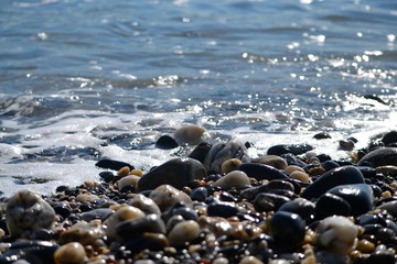 Pebbly beach sea foam