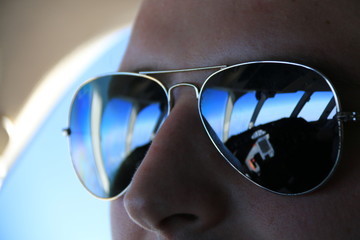 Flight deck reflecting in the pilot's sunglasses