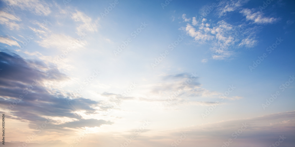 Wall mural blue sky clouds background. beautiful landscape with clouds and orange sun on sky