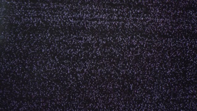 unplugged from television cable TV-set with flashing ripples on black-and-white screen extreme close view
