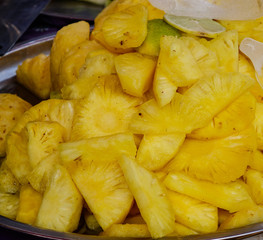 Cutting pineapple fruits for sale at street market