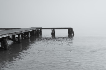 Wooden jetty by the sea during the morning fog. Baltic Sea, Sopot Poland