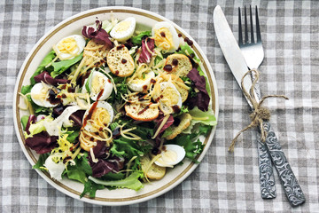 Keto diet. Healthy salad with quail eggs and cheese.