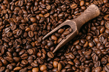 roasted coffee beans with a wooden spatula for coffee