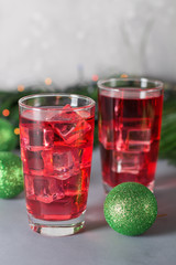Glass of mango dragonfruit refresher drink on table with ice cubes. Copy space.
