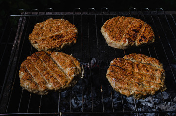 chicken burger composition on a bbq grill