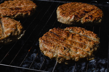 chicken burger composition on a bbq grill
