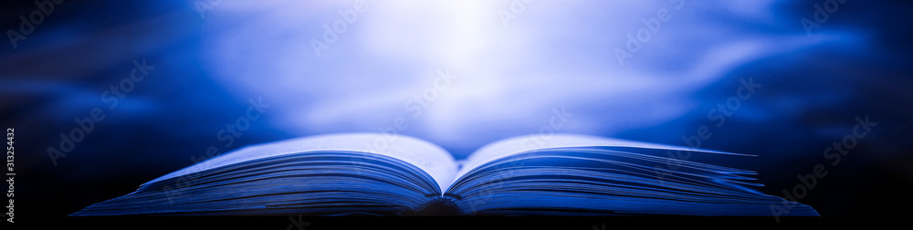 Poster imagine a picture book of an ancient book opened on a wooden table with a sparkling golden backgroun