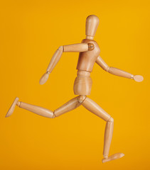 Wooden doll in run pose