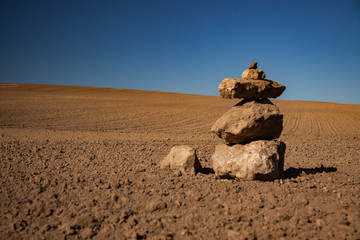 a pile of stones on the field in the sunshine