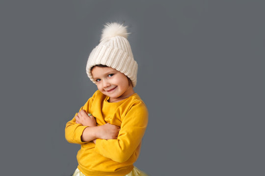 Funny caucasian child in knitted hat with pompom