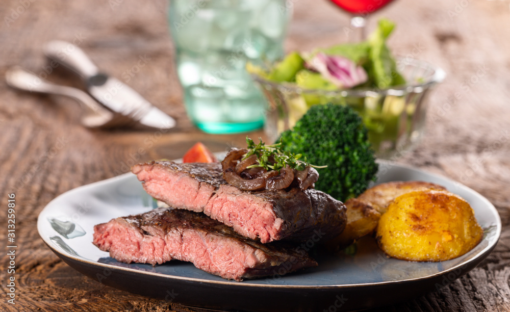 Sticker halves of a steak on a plate