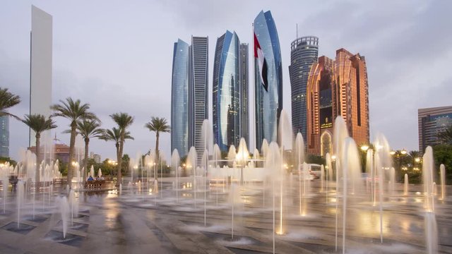Etihad Towers time lapse viewed over the fountains of the Emirates Palace Hotel, Abu Dhabi, United Arab Emirates, Middle East