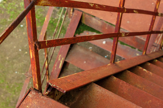 metal stairs. abandoned urban background full of rusty texture. view downside