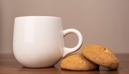 cup of coffee and cookies on wooden table