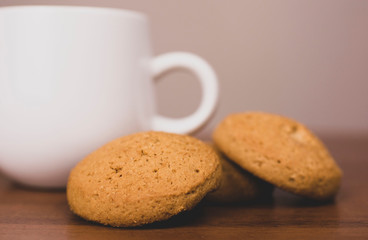 cup of coffee and cookies on wooden table