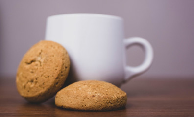cup of coffee and cookies on wooden table