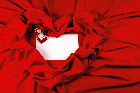 valentine card composition on a red fabric. there is always some madness in love let me be yours message. 