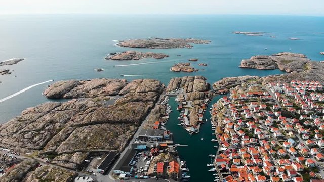 Backwards drone aerial flight with view of amazing rock formations at coastline in Smogen, Bohuslan county, Sweden