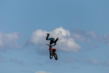 Fototapeta na wymiar Stunt Motocross motorbike rider on a jump