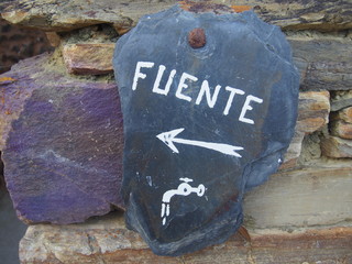 Stone signboard with the inscription "FUENTE (Source)" on the road to Santiago de Compostela, Camino de Santiago, Way of St. James, Journey from Astorga to Foncebadon, French way, Spain