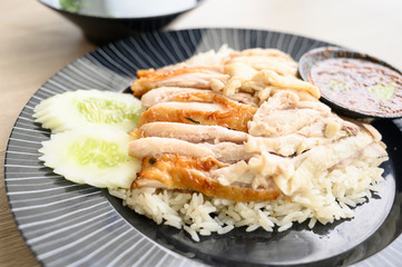 Chicken rice on a black plate