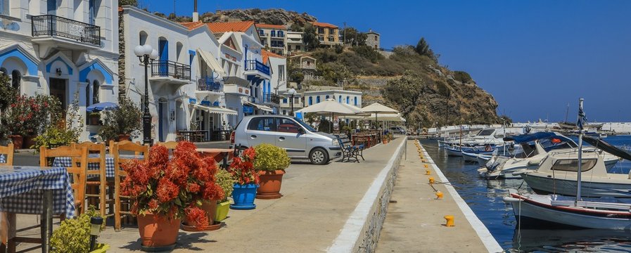 picturesque harbor with traditional greek houses and beautiful mediterranean promenade in Evdilos, Ikaria, North Aegean Islands, Greece
