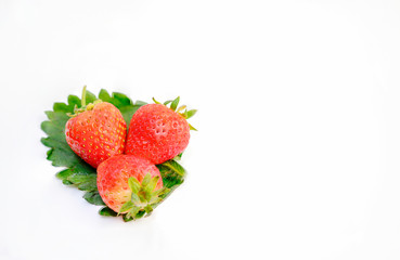 Strawberry fruit and green leaves