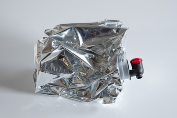 Crumpled plastic wine bag on white background