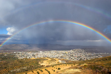 rainbow over the arab village Cana of Galilee ( Kafr Kanna ) in Israel , place where Christ showed first miracle