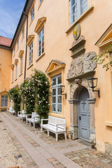 Fototapeta na wymiar Door and benches on the courtyard of Eutin castle in Germany