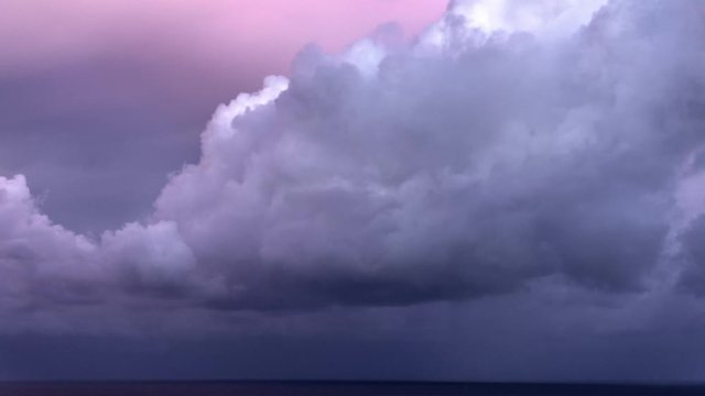 Storm clouds rolling out at sea during sunset