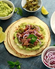 Mexican Corn tortilla with shredded Pork, avocado, red onion and jalapeno
