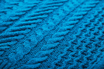 Knitted background. Knitted texture. A sample of knitting from wool. Knitting Pattern.