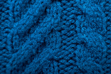 Knitted background. Knitted texture. A sample of knitting from wool. Knitting Pattern.