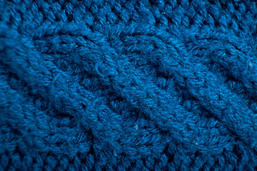 Knitted background. Knitted texture. A sample of knitting from wool. Knitting Pattern.