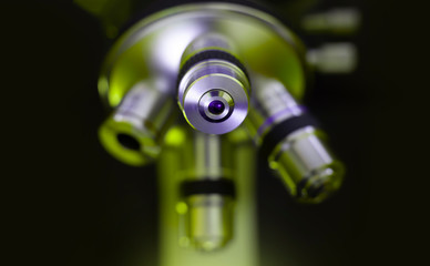 Optical microscope in green tone. Science study and microscopic observation in laboratory.