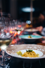 Pasta on plate in restaurant at night
