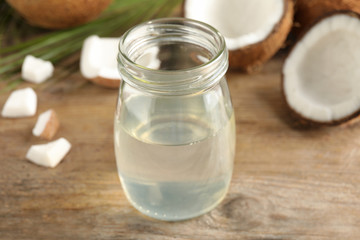 Coconut oil on wooden table, closeup view