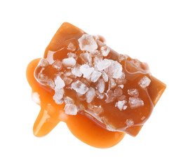 Delicious salted caramel with sauce on white background, top view