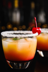 Fresh alcoholic Tequila Sunrise cocktail on black table