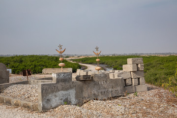 Cemetery at Joal-Fadiouth. Christian graves and crosses next to large baobabs. Fadiauth Island. Senegal. West Africa.