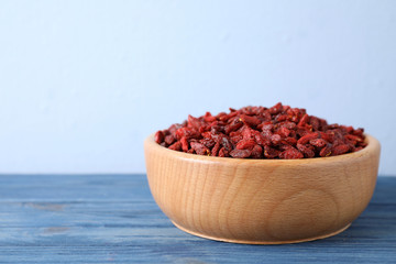 Dry goji berries on blue wooden table, closeup