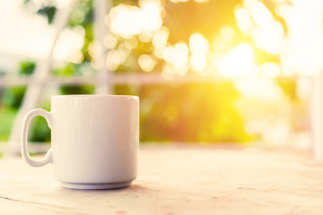 A cup of coffee on the table in the morning.