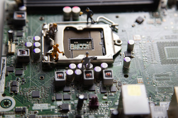 miniature people Motherboard and  CPU repair, Concept: working in technical teams,