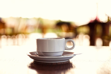 hot cup of coffee on the wood table in the morning.